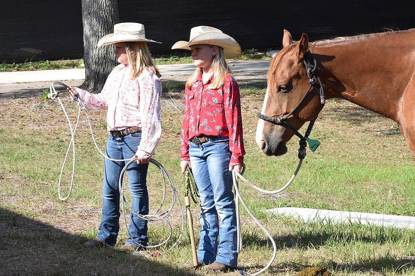 Cady and Cooper Jones, who are both 10, stand with Spade, the horse.
