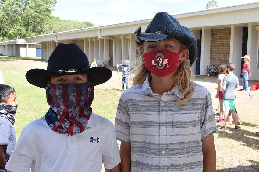 Charlie Westrip and Wyatt Lawhun, fourth graders, wear cowboy hats to get in the spirit of learning about life in a ranch.