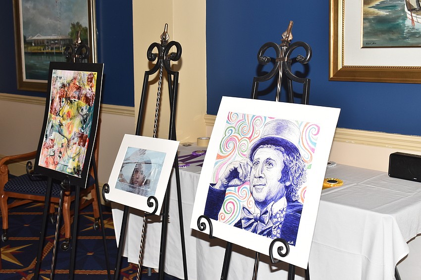 The art winners displayed their pieces at the front of the room.