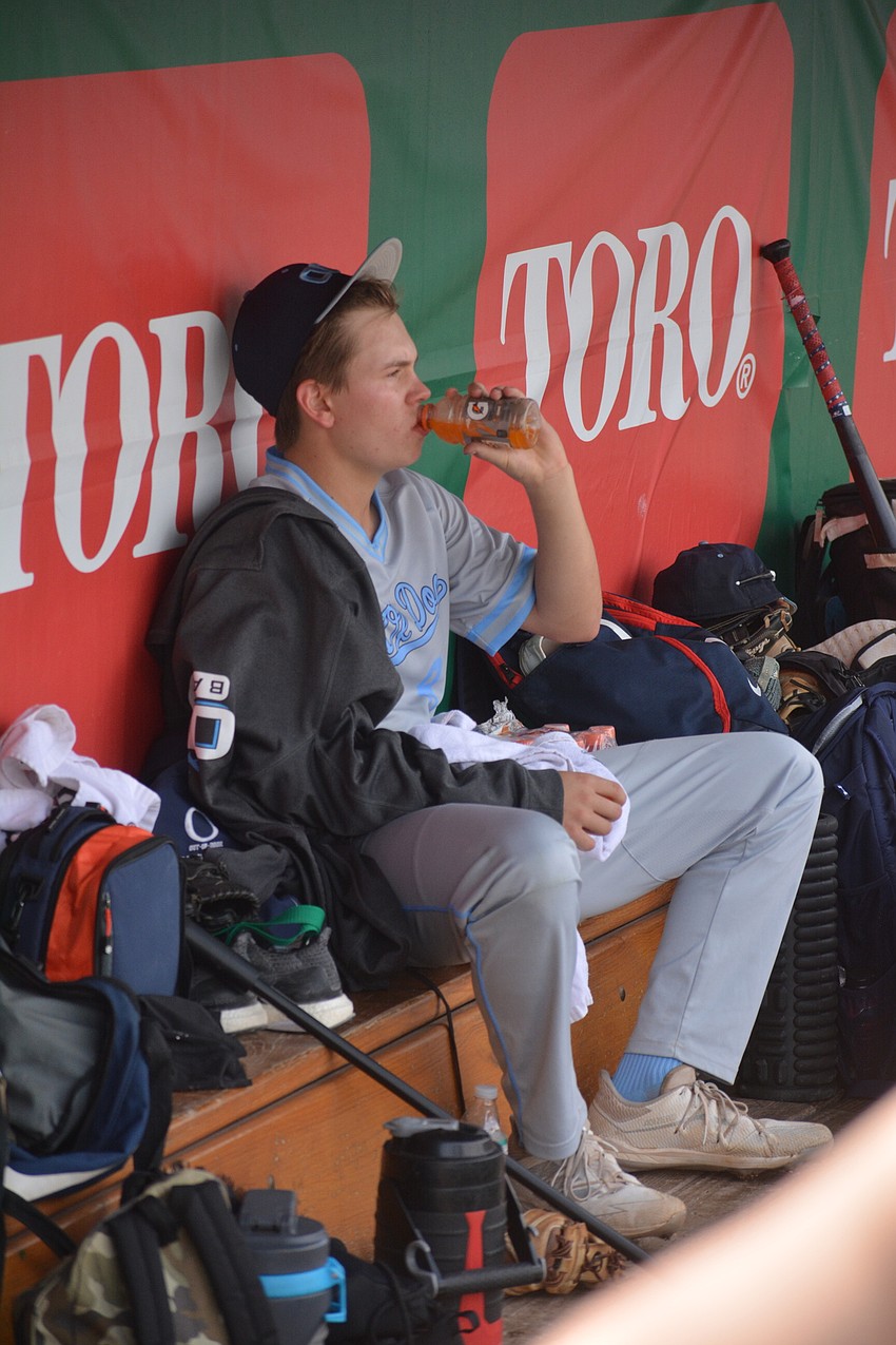 ODA sophomore pitcher Luke Geske hydrates in the dugout between innings.