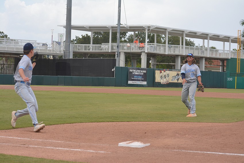 ODA sophomore Luke Geske catches a toss from senior Tyler Colditz to get a runner at first base.