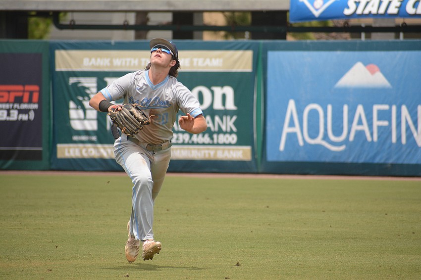 ODA junior Carter Dierdorf runs to catch a ball in right field.
