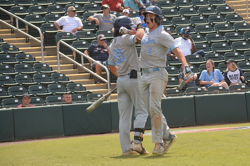 ODA junior Carter Dierdorf and senior Ryan Kelly bump arms after Kelly scored the go-ahead run.