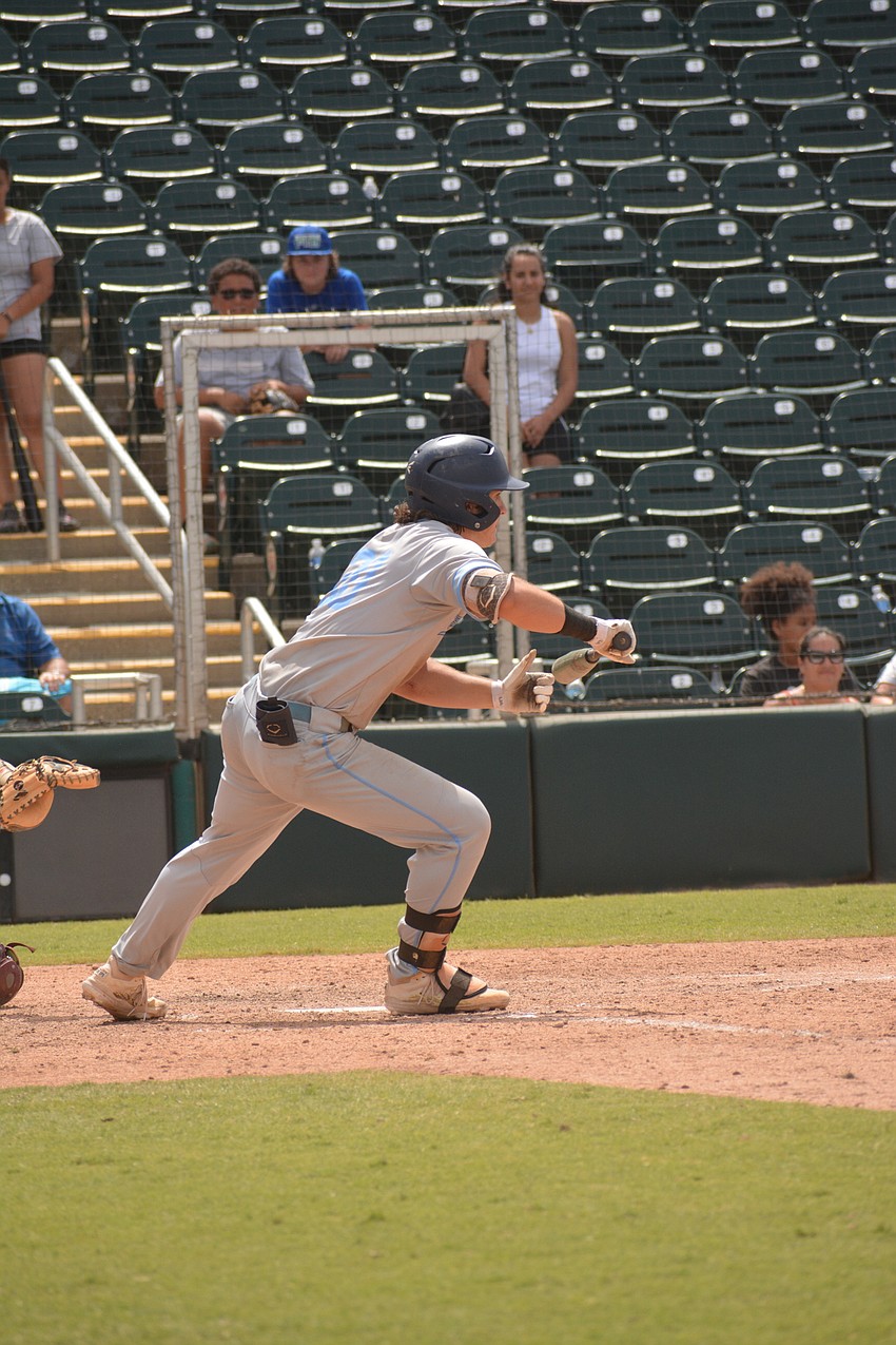 ODA junior Carter Dierdorf lays down a bunt in the seventh inning to score another run.