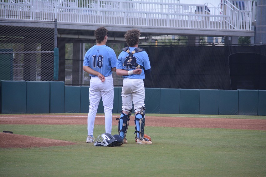 ODA junior pitcher Josh Cone and senior catcher PJ Fincher stand for the National Anthem before the state title game.