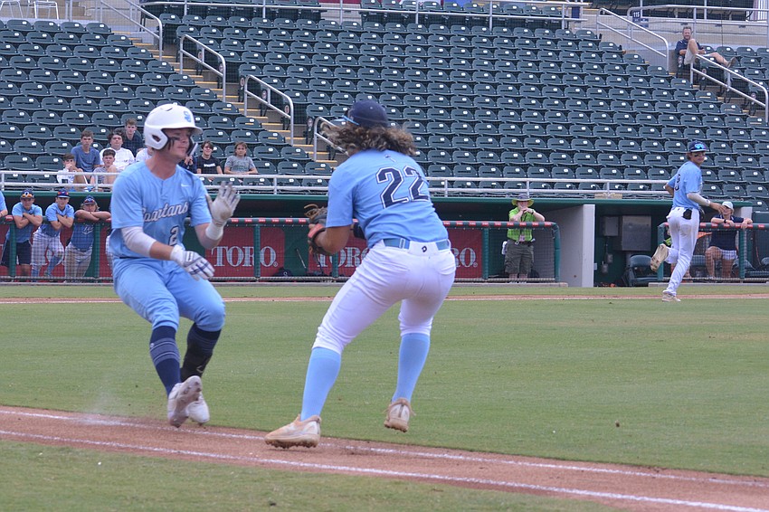 ODA senior Tyler Colditz (22) tags a St. Johns runner out on a grounder.