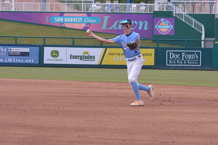 ODA freshman Nolan Naese tosses a ball to first base for an out.