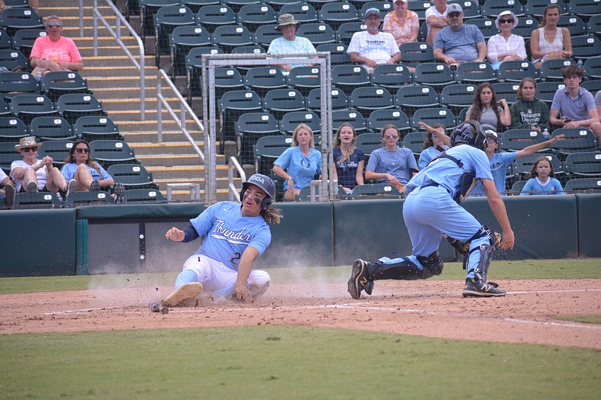 ODA senior Tyler Colditz slides into home to score the Thunder's first run of the game.