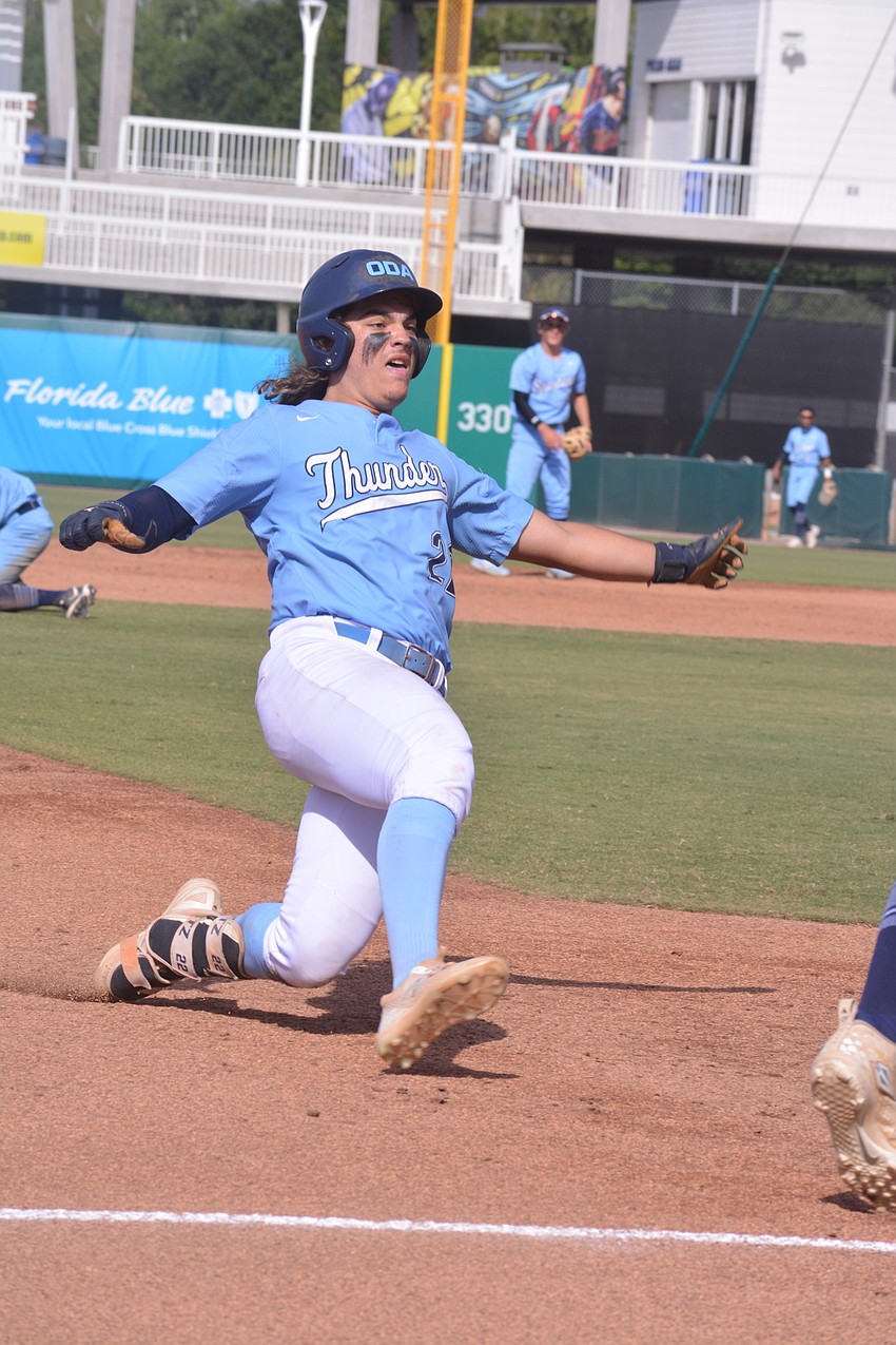 ODA senior Tyler Colditz slides into third base on an attempted triple. Colditz was called out.