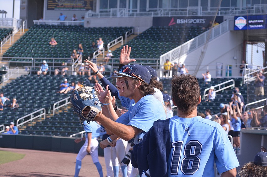 ODA players cheer on their teammates from the top step of the dugout at Hammond Stadium in Fort Myers.