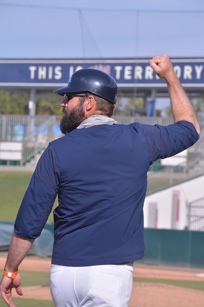 ODA coach Mike Matthews pumps his first following senior Nolan Lewellen's sixth-inning home run.