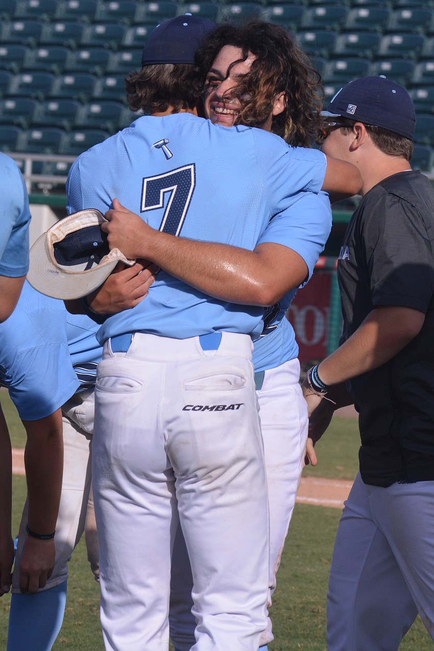 ODA seniors Nolan Lewellen (7) and Tyler Colditz hug after the team's state championship win.