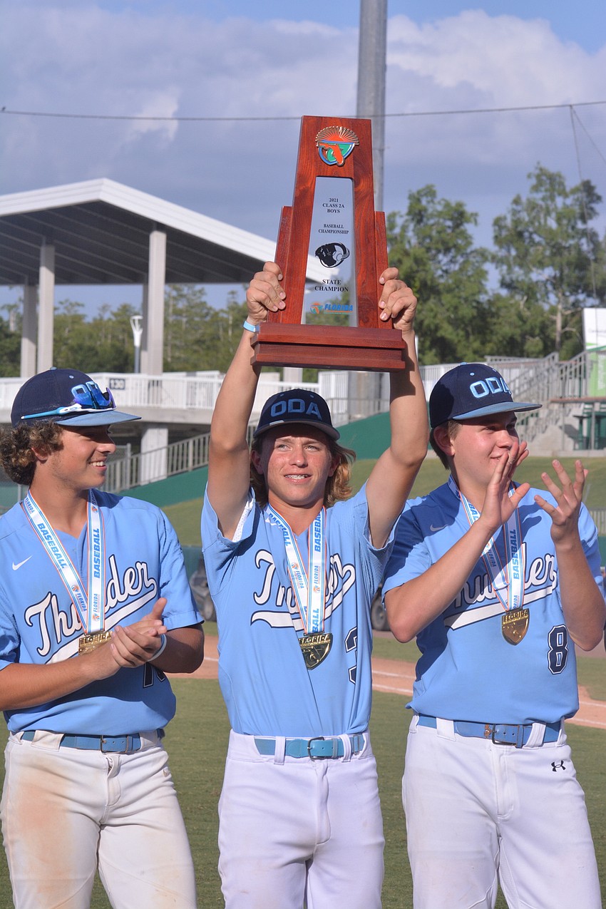 ODA junior Jackson Malartsik raises the trophy over his head.