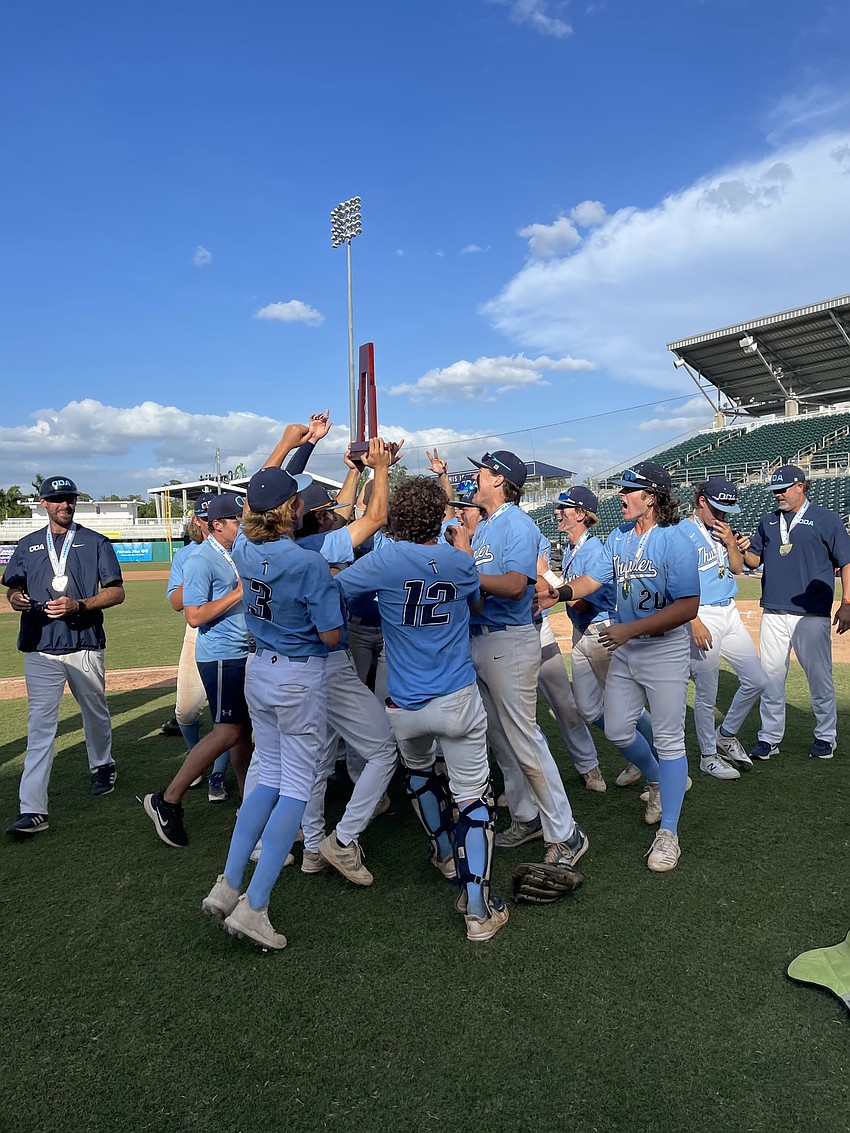 ODA mobs the Class 2A state championship trophy.