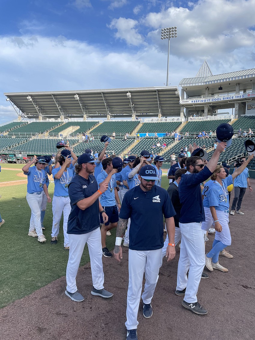 ODA players and coaches tip their caps to the fans for their support.