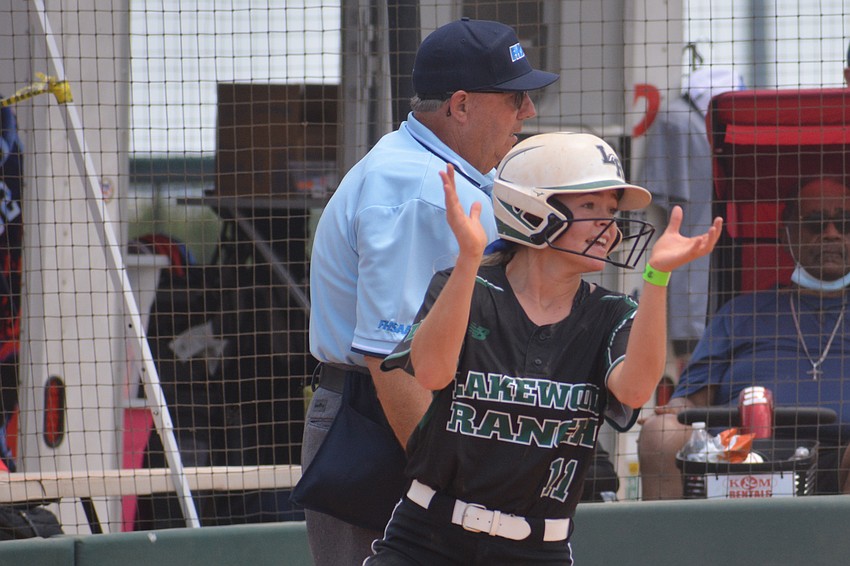 Lakewood Ranch junior Jayla Daoust claps after scoring as a substitute runner in the first inning.
