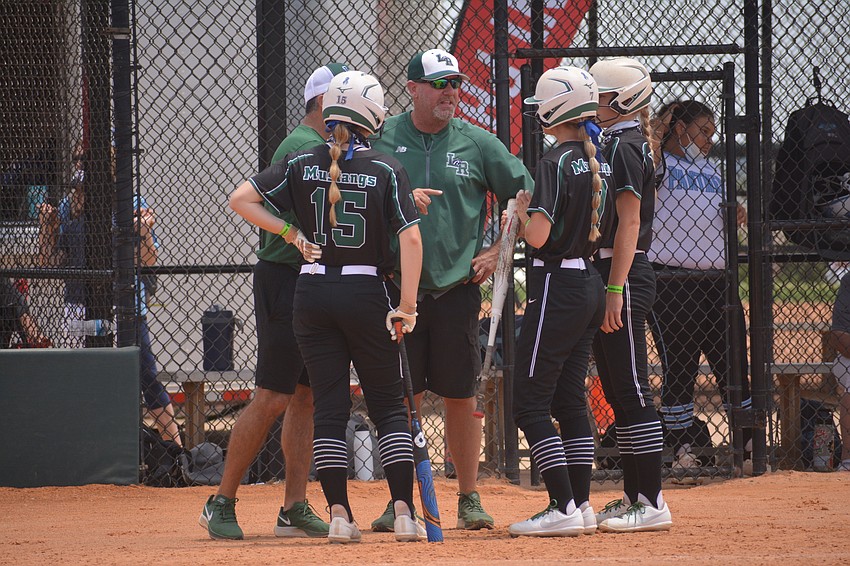 Mustangs Coach TJ Goelz chats with his offense in the first inning.
