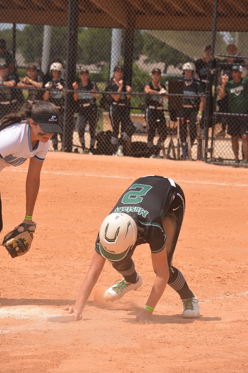 Lakewood Ranch sophomore Addyson Bruneman stands up after sliding into third base on a pickoff attempt. Bruneman was called safe.