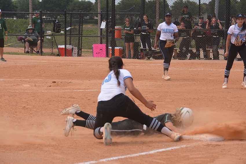 Lakewood Ranch junior Jayla Daoust slides into third base and avoids the tag from Miami Palmetto senior Olivia Rapp.