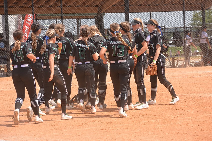 The Mustangs mob the field after defeating Miami Palmetto 17-2 to advance to the state championship game.