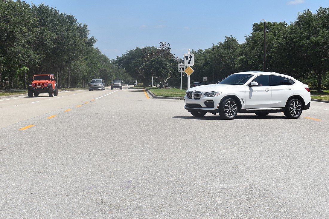 A car sits in the middle of Lakewood Ranch Boulevard while waiting to complete its southbound turn, which began on Balmoral Woods Boulevard. Country Club residents said they fear an accident could happen because of this technique.