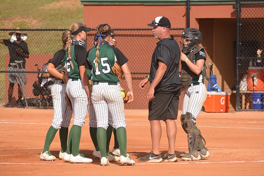 Mustangs Coach TJ Goelz chats with his defense at the mound in the first inning.