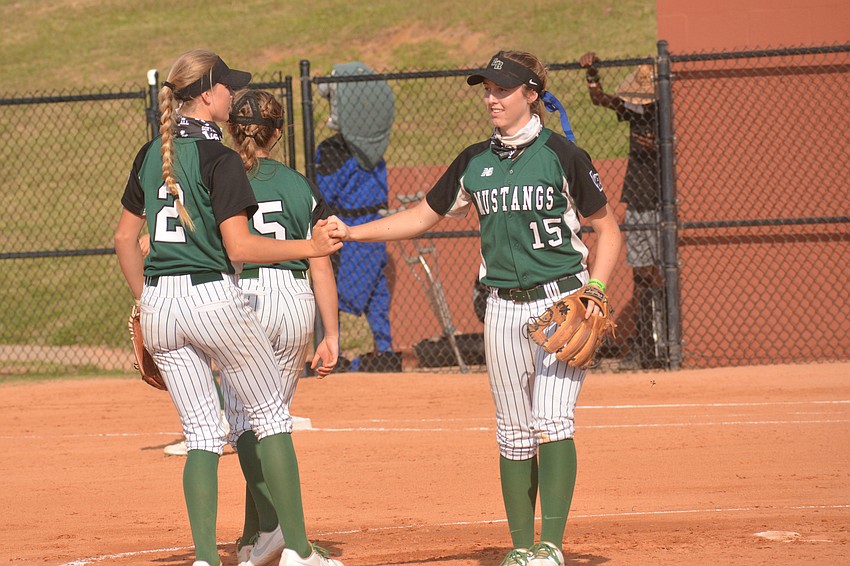 Lakewood Ranch sophomore Addyson Bruneman (2) and sophomore Amanda Lee share a secret handshake after an out in the second inning.