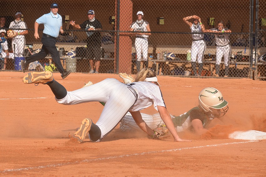 Lakewood Ranch junior Grace Hogie slides into third base. Hogie was called safe because of interference by Park Vista.