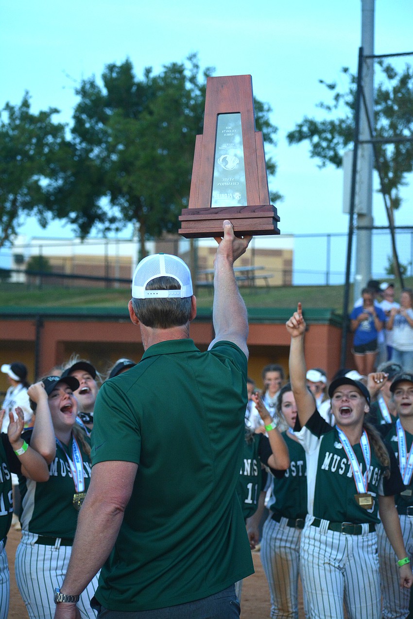 Lakewood Ranch Athletic Director Kent RIngquist shows the Mustangs their state championship trophy.