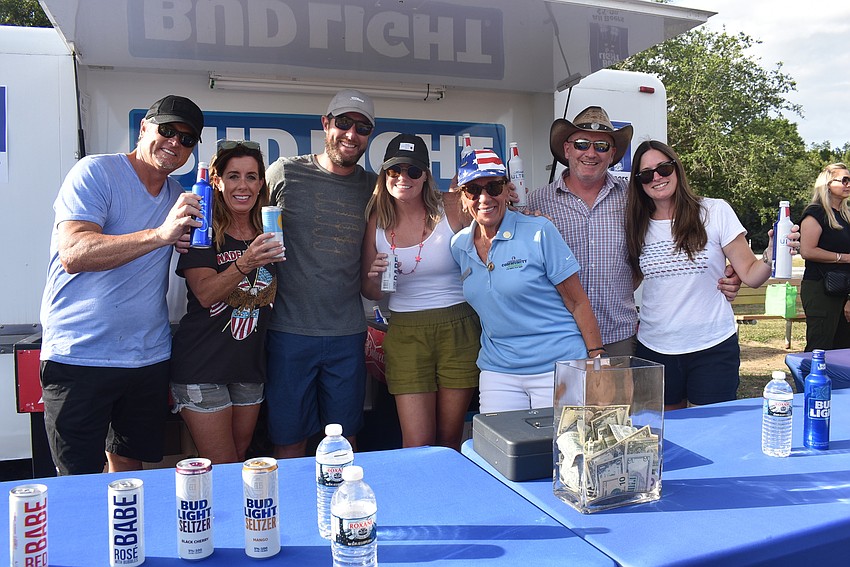 Greenbrook's Mark Ulrich, Allison Ulrich, Brad Zabel, Sarah Zabel, Lakewood Ranch Community Activities Vice President Carlene Smith, Greenbrook's Jeff Dowling and Susan Dowling lift their drinks to toast veterans.
