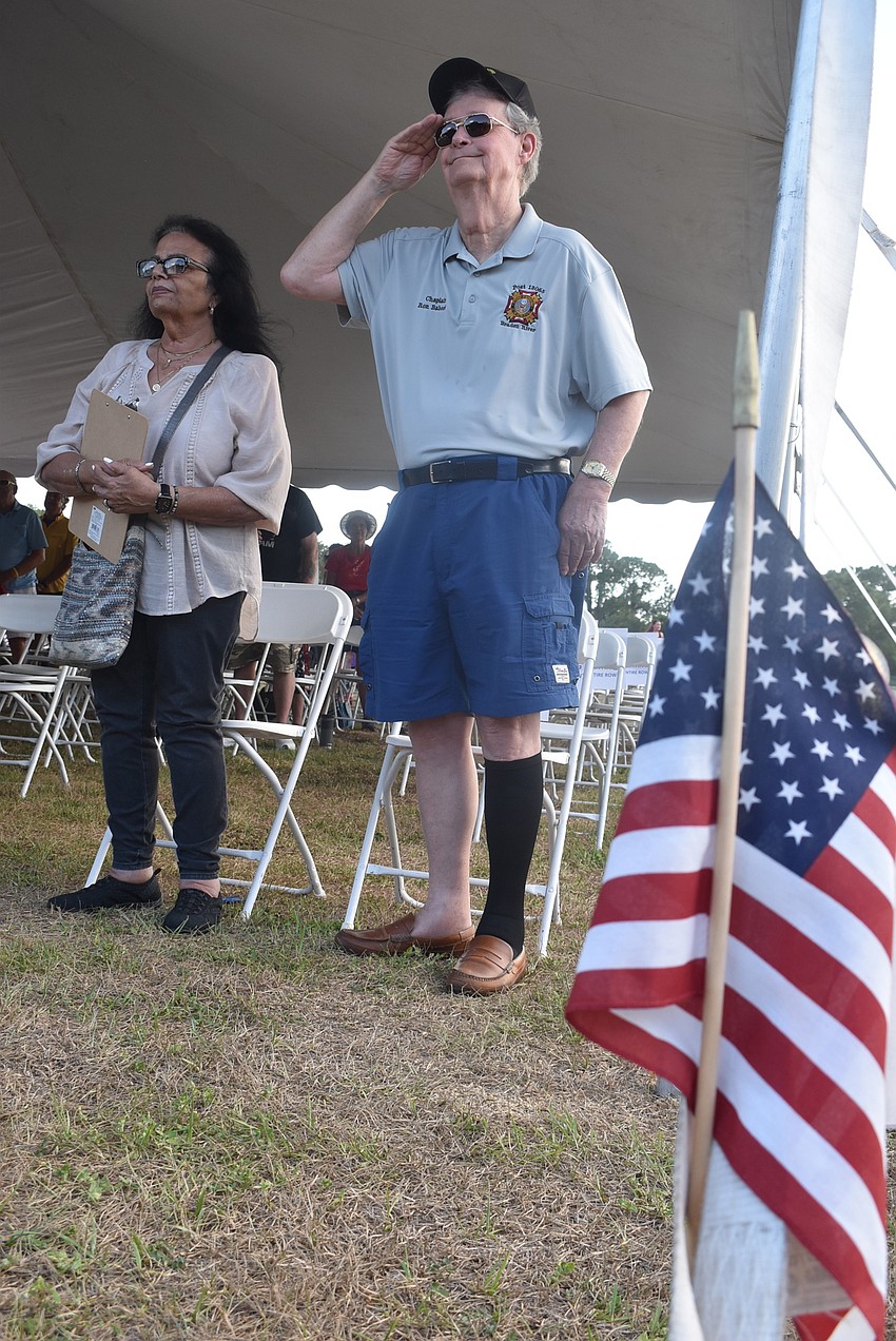 Lakewood Ranch residents Yardena Babcock and Chaplain Ron Babcock stand at attention during Whiskey Blind's rendition of the Star-Spangled Banner. Ron Babcock served in the Navy during the Vietnam War for four years.