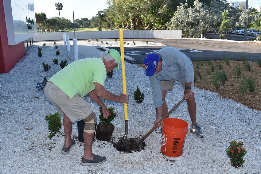 Jim Brown and Mike Haycock dig up dirt out front.
