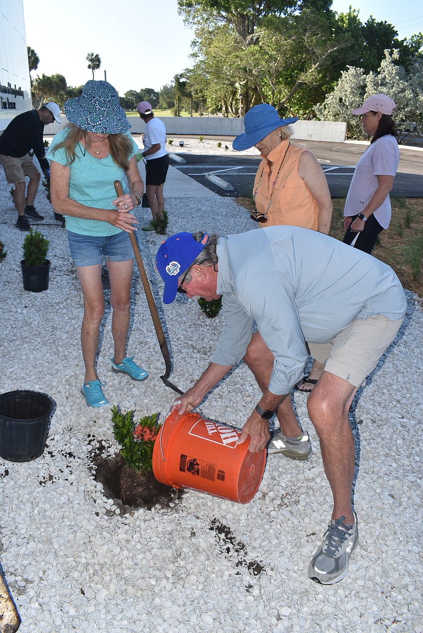Mike Haycock fills in dirt.