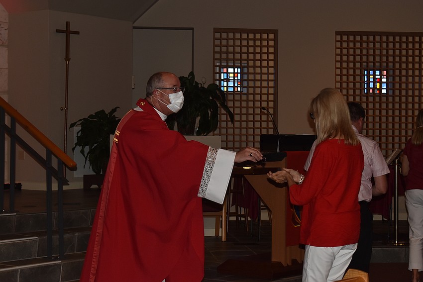 Rev. Ken Blyth still kept his mask on while giving out communion, but many attendees went mask-free.