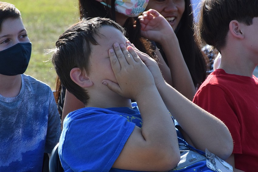 Devan Durrance, a fifth grader, covers his eyes as a Circus on the Ranch performer flies through the air. 