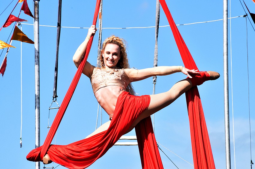 Lexi Sutherland with Circus on the Ranch strikes a pose while doing a routine using silks.