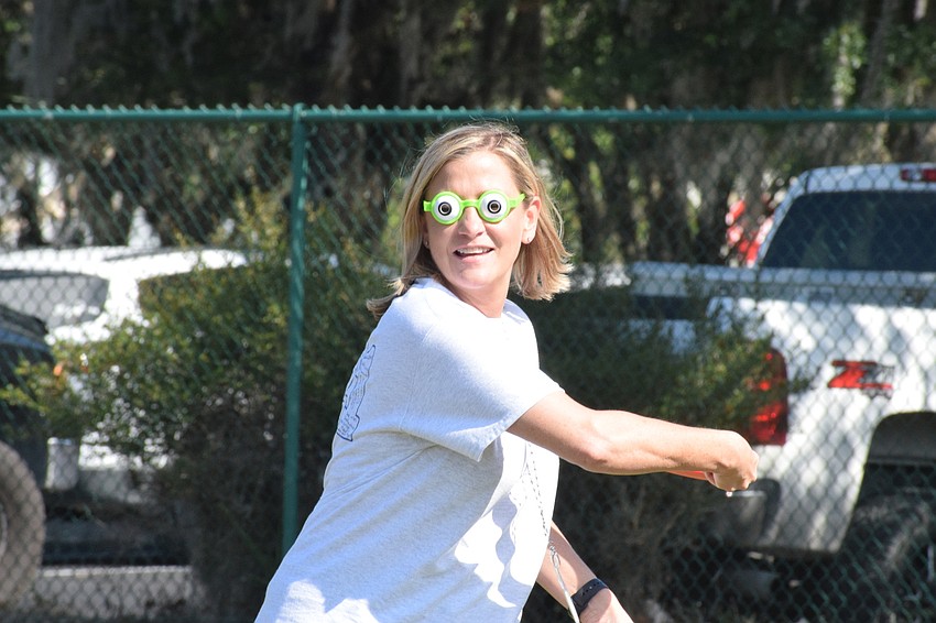 While wearing special glasses, Gena Case, the guidance clerk, throws a disc in hopes of having it land on the head of Yvinson Acero with Circus on the Ranch..