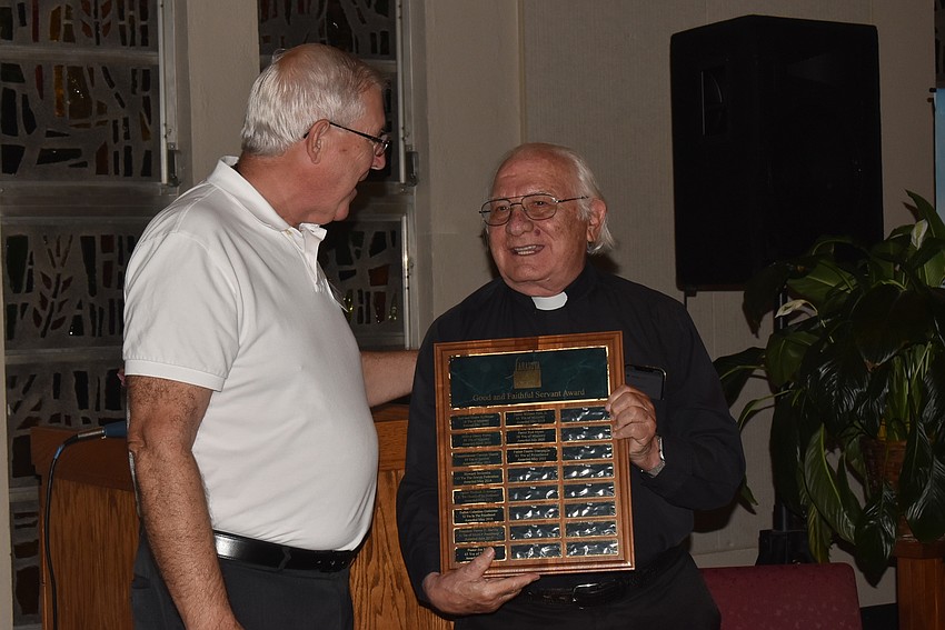 Rev. Rod Myers passes the Good and Faithful Servant Award forward to Father Fausto Stampiglia, who was the 2021 winner.