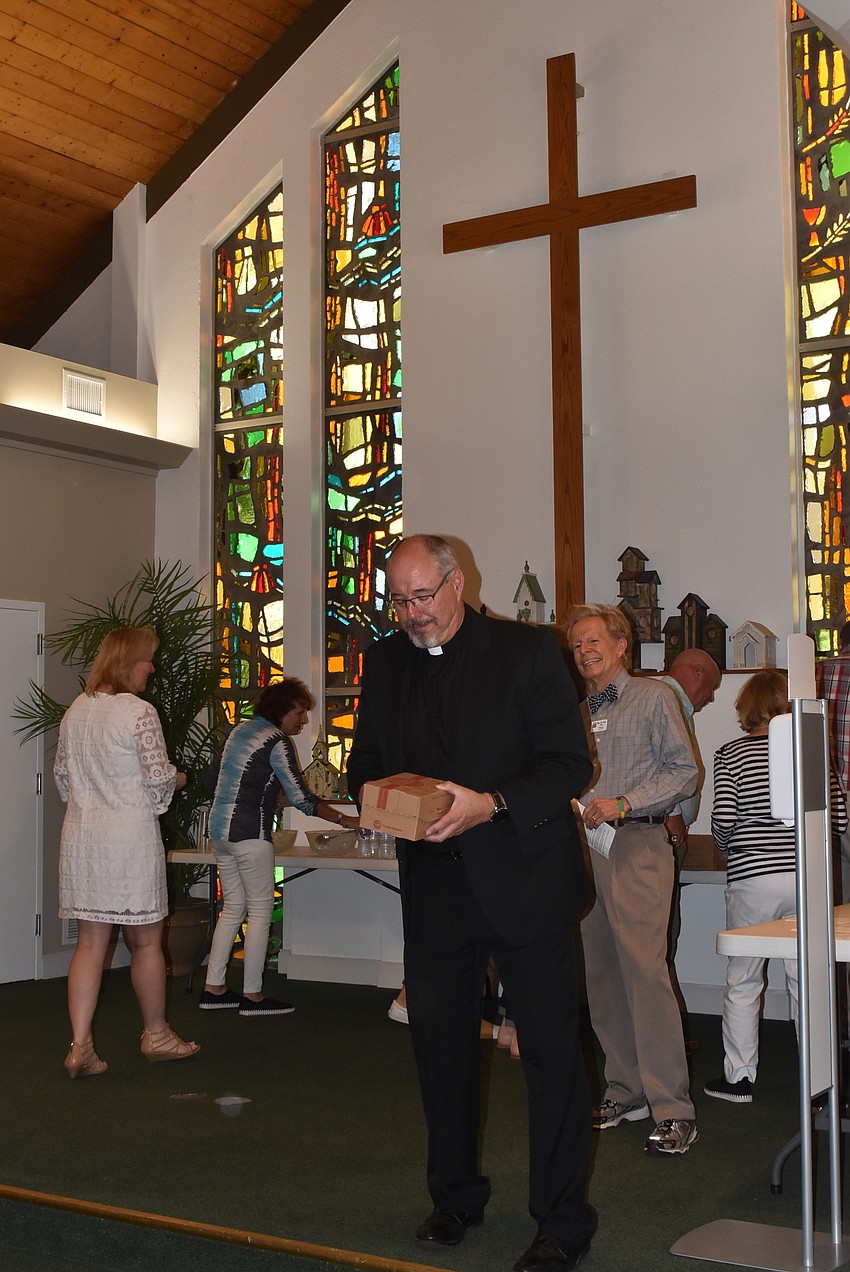 Rev. Ken Blyth got the luncheon going by starting the line for food.