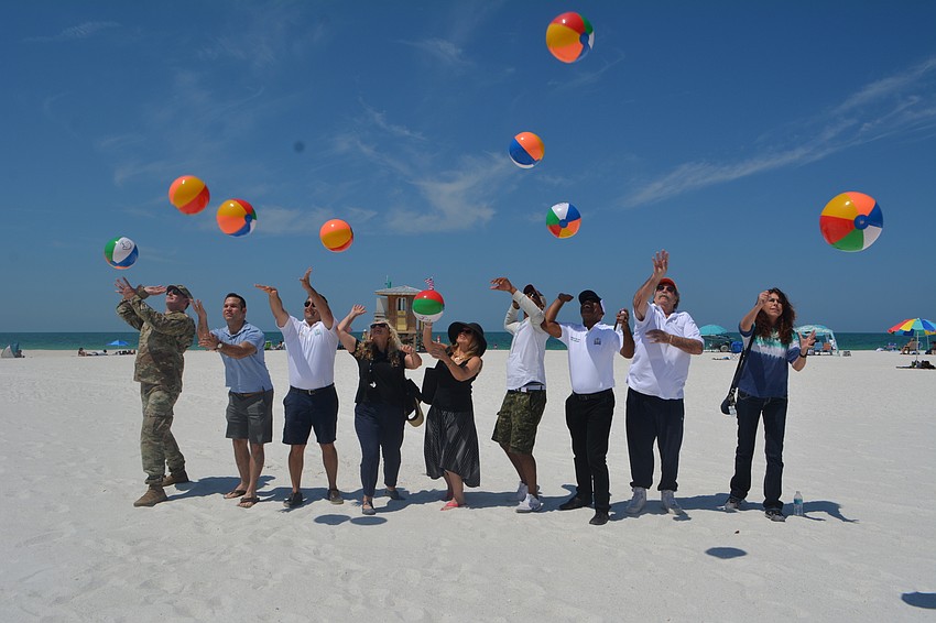 Army Corps Lt. Col. Todd Polk, commissioners Erik Arroyo, Hagen Brody, Jen Ahearn-Koch, Liz Alpert and Kyle Battie, City Manager Marlon Brown, Lido Key resident Carl Shoffstall and City Engineer Alex DavisShaw bat beach balls.