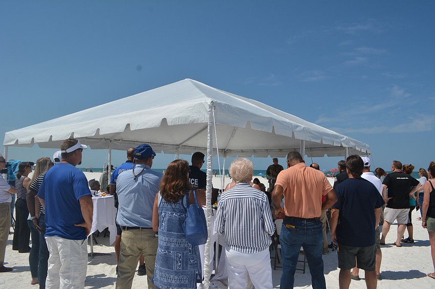 Attendees listen to remarks from Army Corps Lt. Col. Todd Polk. The Army Corps and the city teamed on the shoreline protection project.