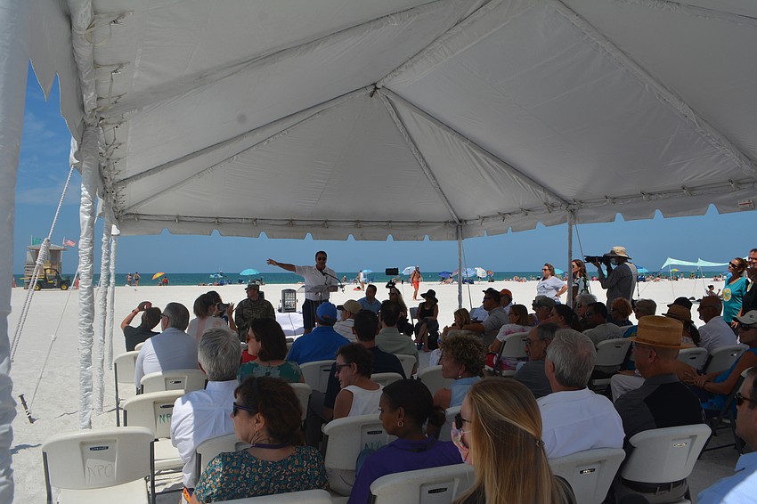 Mayor Hagen Brody reminds the audience of the precarious state of the beach prior to the renourishment.