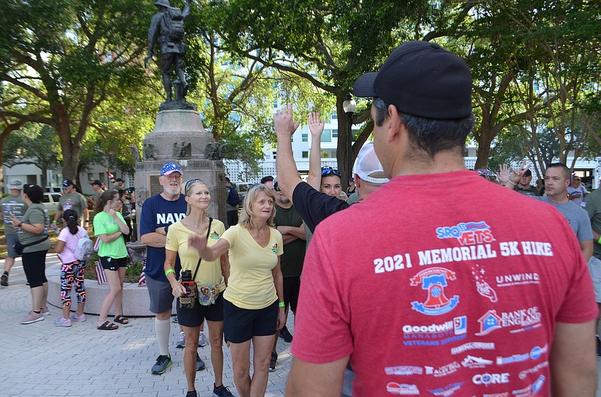 Bill Sterbinsky addresses the gathered crowd on the hike's route and safety concerns.