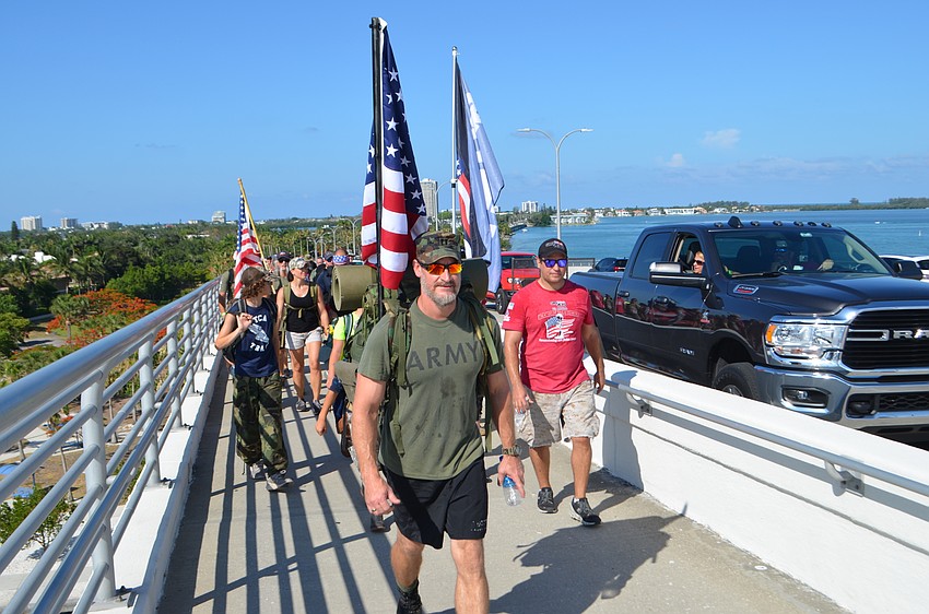 A truck slowed at the top of the bridge to offer hikers water.
