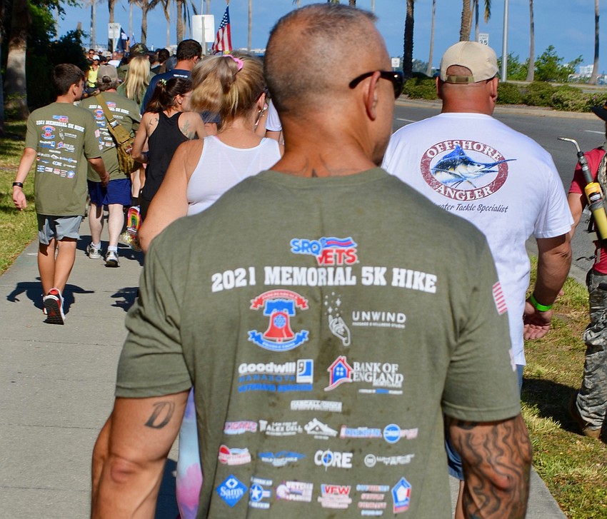 Joe Dralus, walking with his friend and fellow veteran Mike Keller, wore his event T-shirt proudly.