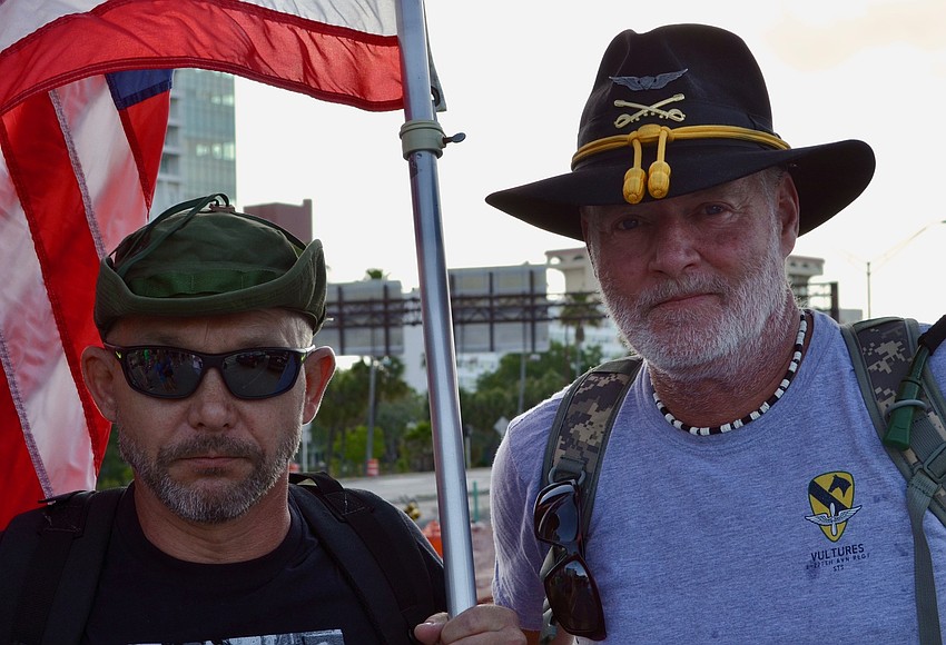 Michael Sabuda, left, and James DeMass carried the American flag with them.