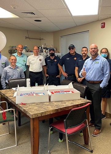 Fire department employees and Publix employees chatted when the cakes were dropped off. Courtesy photo.