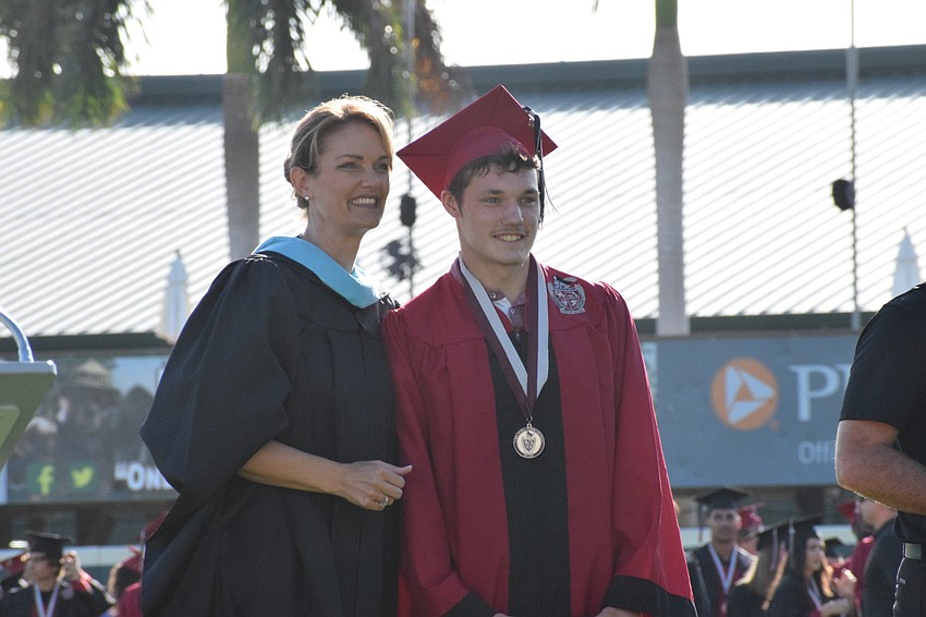 Principal Sharon Scarbrough and senior Justin Alderman celebrate Alderman's graduation from high school.