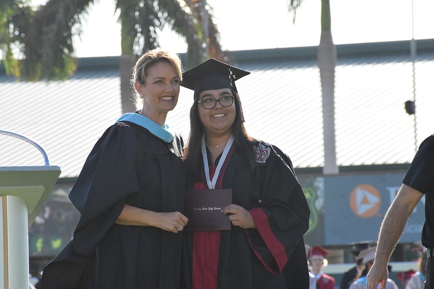 Principal Sharon Scarbrough congratulates senior Payton Dreier.