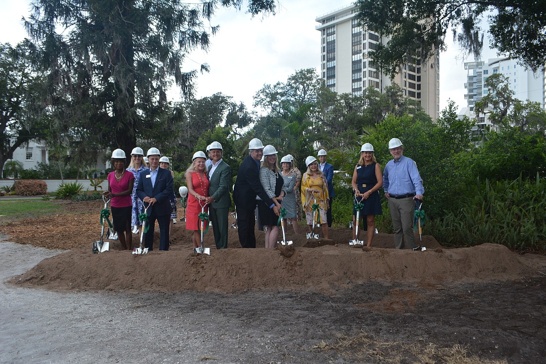 Members of the Marie Selby Botanical Gardens board of trustees pose before shoveling dirt at todayâ€™s groundbreaking ceremony.